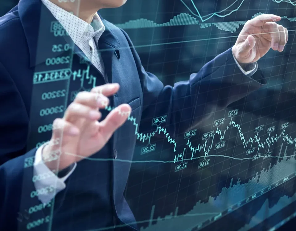 Businessperson reviewing investment banking services reports and growth charts on a laptop, symbolizing how financial advisory and funding support business growth.